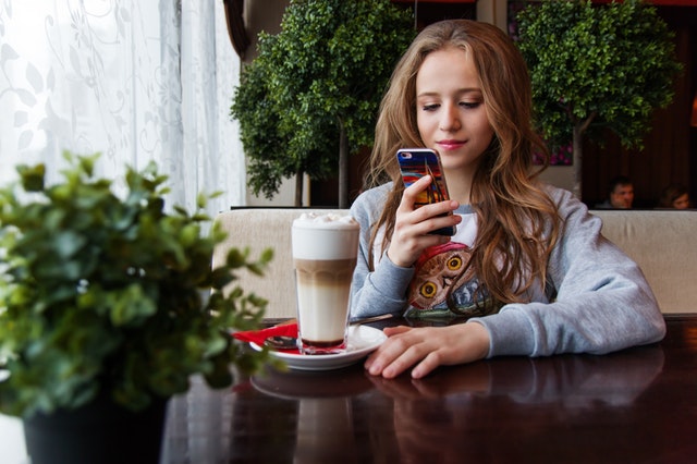 A picture of a young girl on her phone