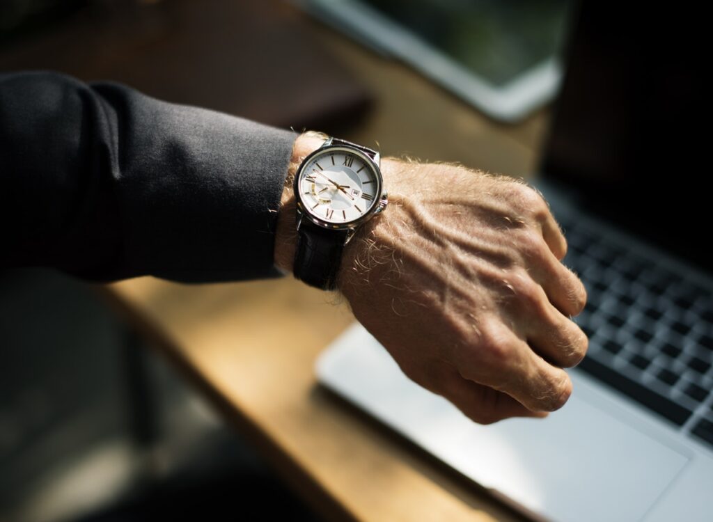 Image of a man checking his watch