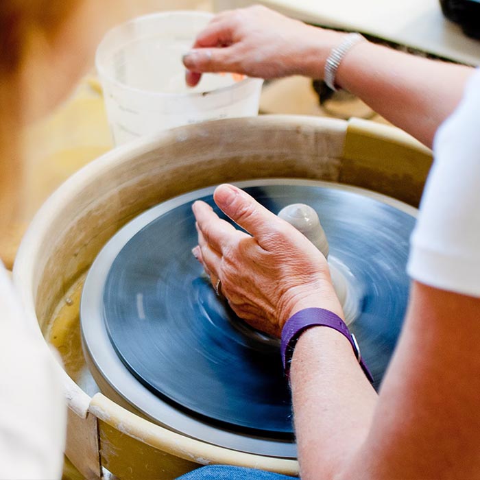 In the making of pottery process with female model